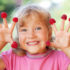 Little girl with raspberry