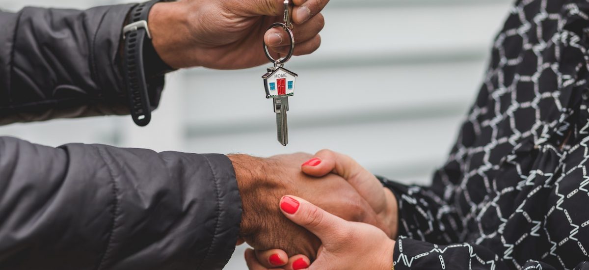 Agente inmobiliario entregando llaves a nuevo propietario